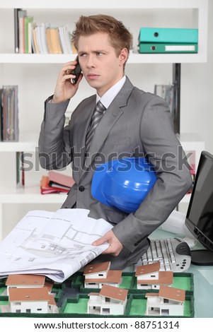 An annoyed architect talking on the phone