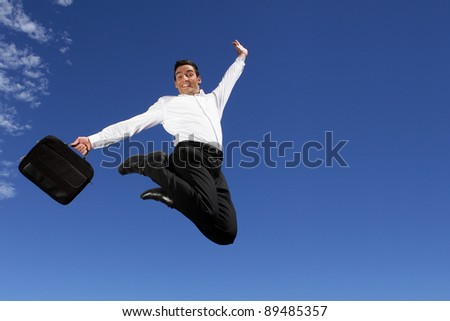 Happy businessman jumping in the air