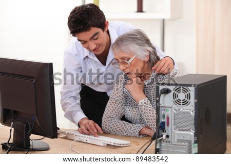 Young man showing grandmother computer