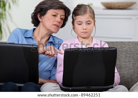 Girl with her grandmother and laptop computers