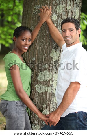 Couple touching tree