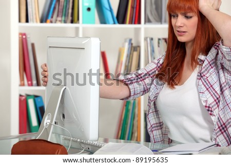 Young woman having trouble with computer