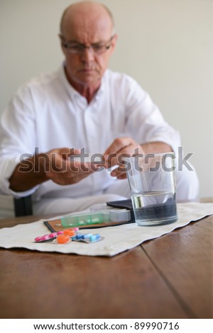 Elderly man taking medication