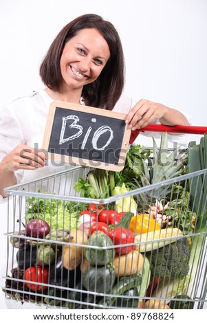 Woman with a trolley of organic vegetables