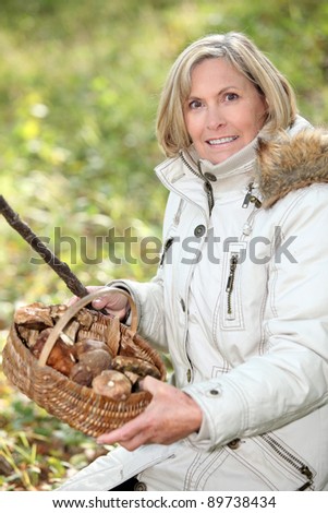 senior woman gathering mushrooms