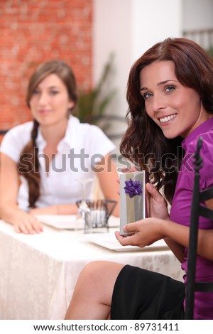 Woman in restaurant with birthday present
