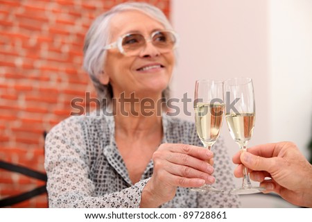 Elderly couple toasting in restaurant