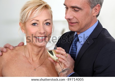Middle-aged couple drinking champagne