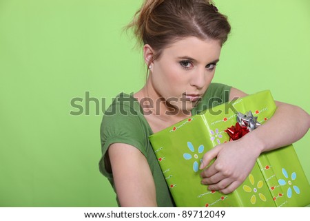 Greedy woman hugging her present all to herself