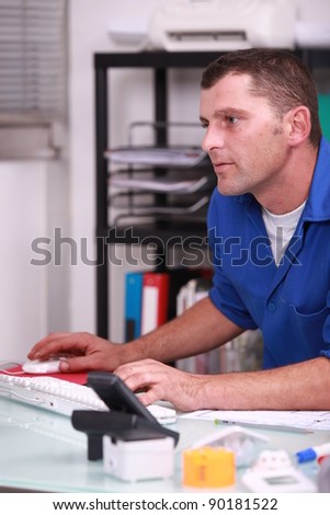 Plumber using a desktop computer