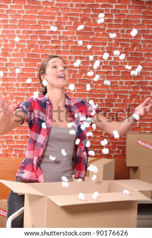Woman throwing up packing peanuts