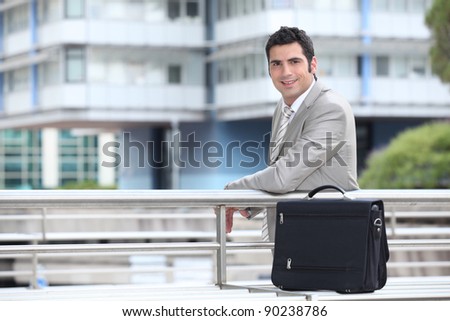 Businessman with a briefcase standing in an urban environment