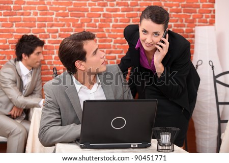Co-workers watching laptop computer