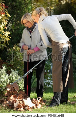 Young woman helping elderly woman to do gardening