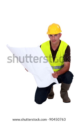 Tradesman studying a blueprint