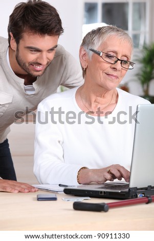 Man helping old lady with computer