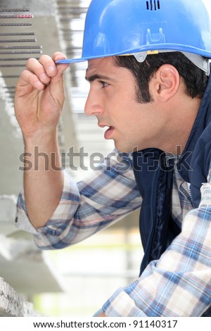 Construction worker touching the brim of his hat