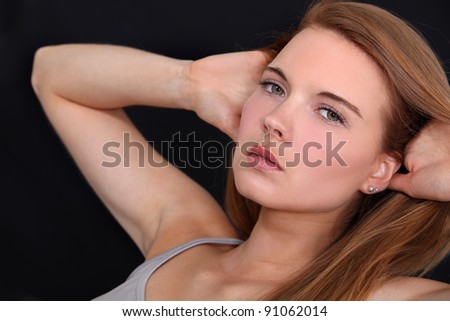 Woman with her hands behind her head