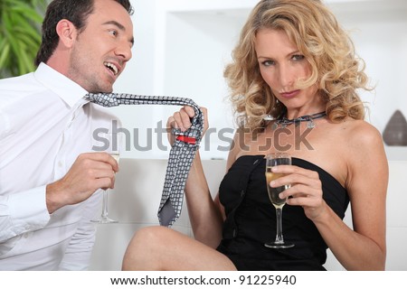 Woman seducing a man with champagne