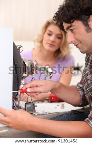 Man repairing broken television