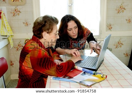 Woman helping grandmother with computer