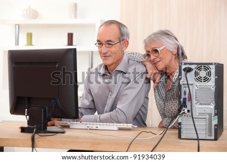 Elderly couple learning computer skills