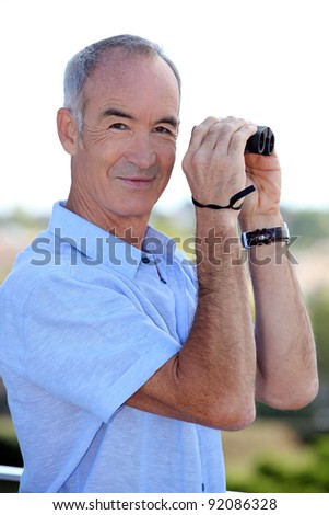 Older man with a pair of binoculars