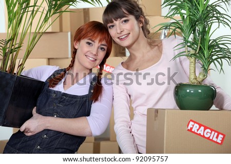 Young women moving into their new apartment