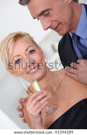 Middle aged couple having champagne.