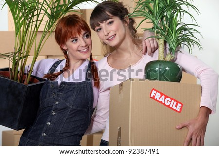 Girls roommates moving into their new apartment