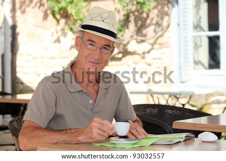 senior citizen sipping his coffee in terrace cafe