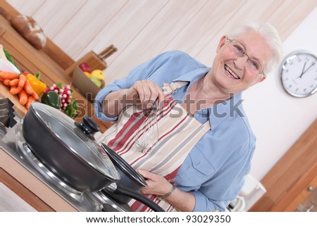 Old lady cooking in kitchen