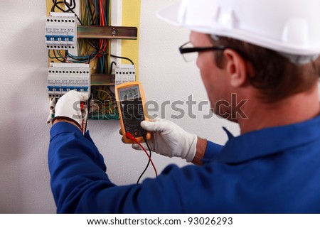 An electrician checking the energy meter.