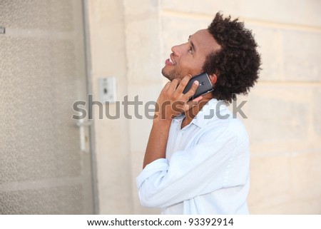 a man at phone in front of a closed door