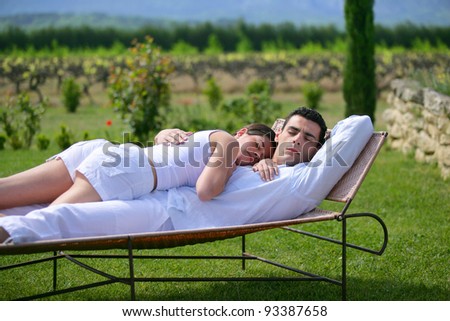 Couple having a nap on sun lounger
