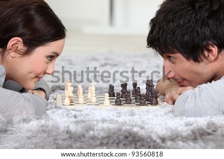 Man and woman playing chess