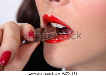 Closeup of a woman eating chocolate