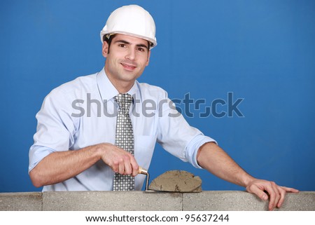Architect laying a block wall