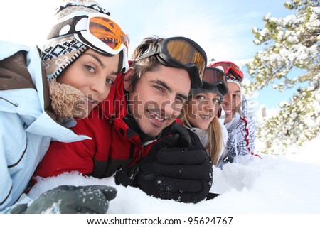 Ski couples lying in the snow
