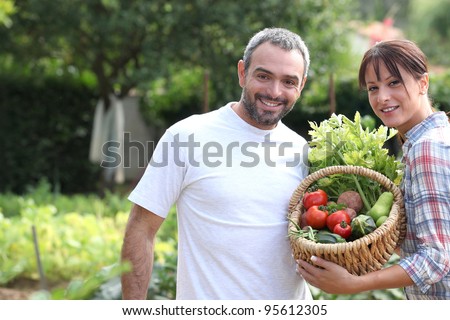 A couple taking care of their vegetable garden.