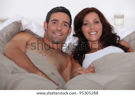 Husband and wife in bed together