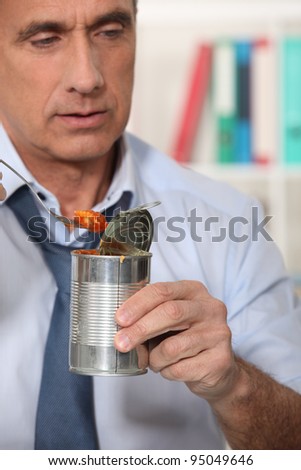 Man eating from tin can
