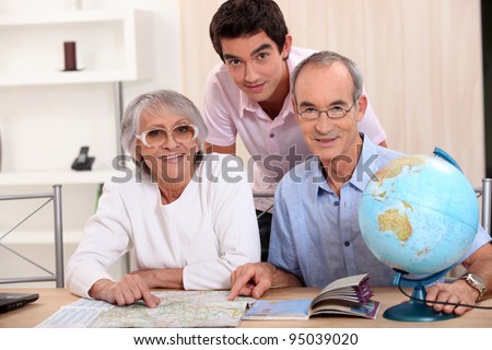 Young man and senior couple seeking a route on a map