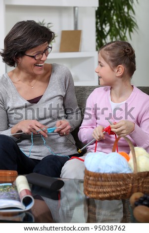 Grandmother knitting with her granddaughter