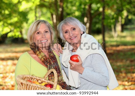 Women gathering apples