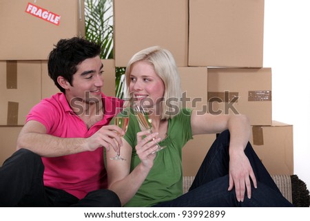 Couple having a celebratory drink on moving day