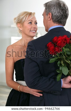 Man surprising his date with roses