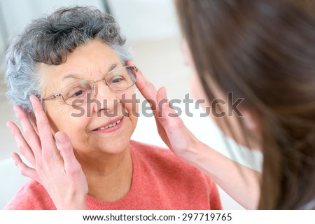 Senior woman testing glasses