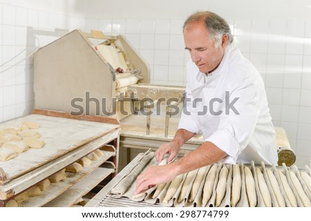 Baker preparing baguettes