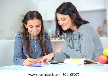 Mom helping her daughter do her homework